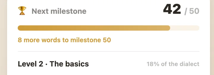 Dialect milestone card: next milestone 42 of 50 words, with progress bars